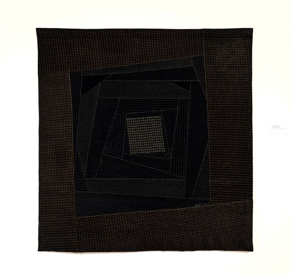 Kyoung Ae Cho - He Was Formal (a quilt in browns and blacks with dot patterns. Concentric rhomboid shapes spiral towards the center)