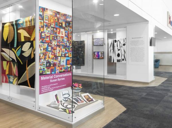 Artwork by Susan Byrnes (installation view of several abstract art quilts in display cases)