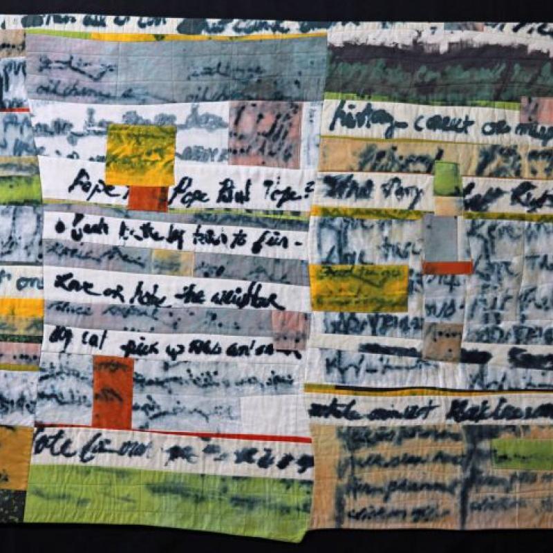 Colleen Ansbaugh - Lost Thoughts (art quilt made of long rectangular strips. Some have thick black writing on them that is not quite readable)